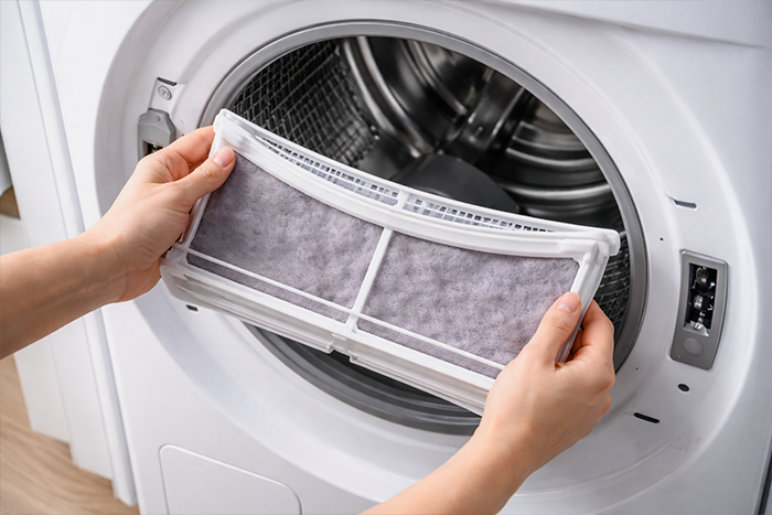 Clean dryer lint filter being removed from modern dryer drum